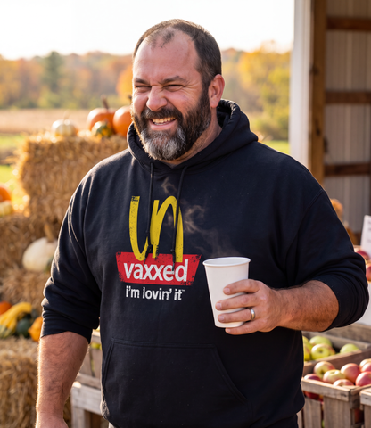 Man wearing the black Unvaxxed Hoodie at a fall farm stand