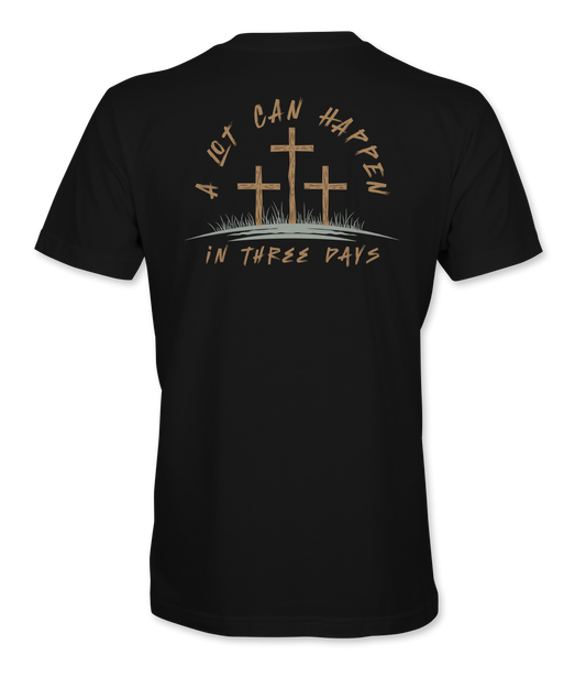 The Alex Jones Store - Back view of black 'A Lot Can Happen In Three Days' t-shirt with three crosses on a hill and tan script Easter design