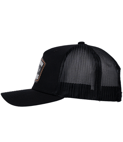 The Alex Jones Store - Support Your Local ICE Raid Trucker Patch Hat — Black trucker patch hat left side view with mesh back panels and partial ICE Raids leather patch visible
