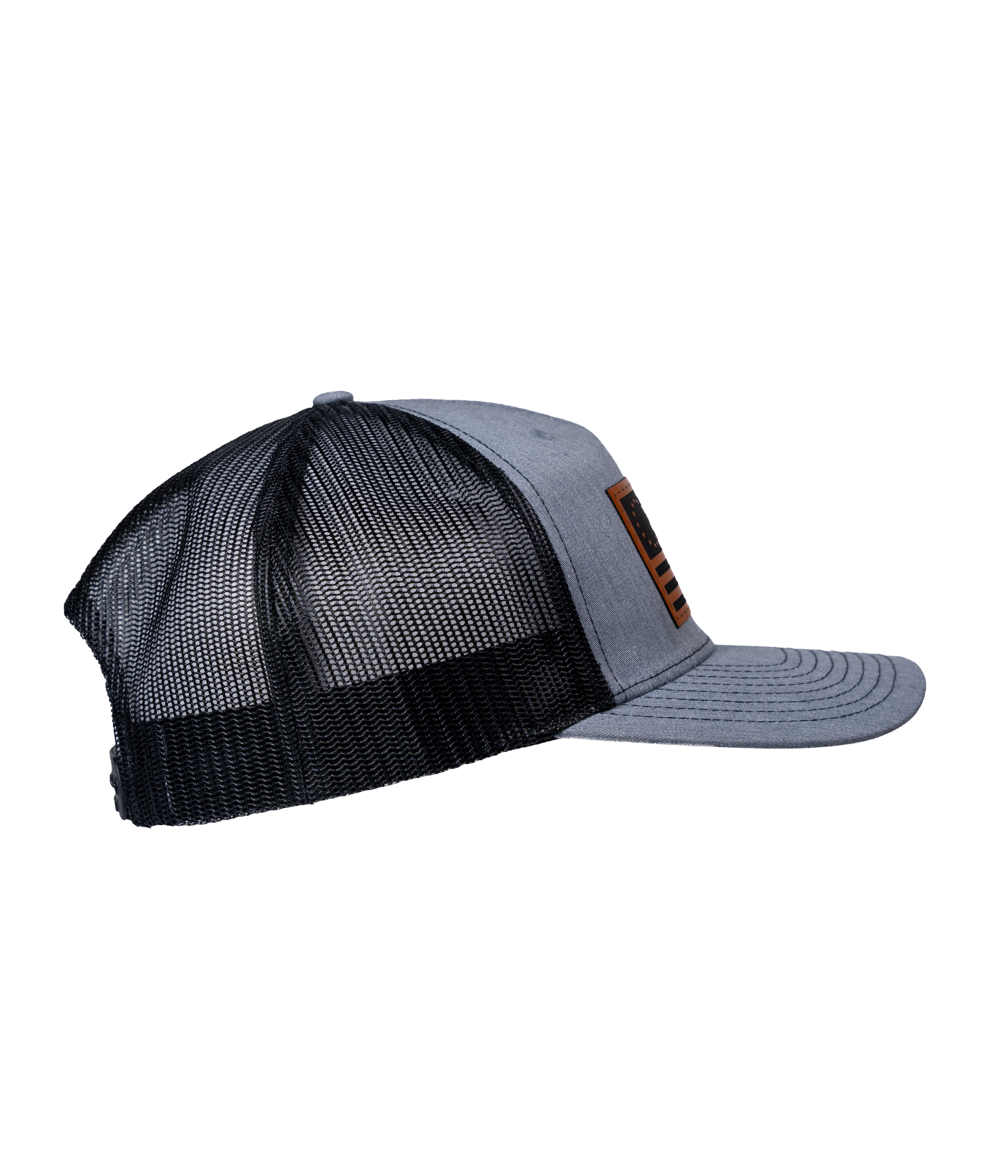 The Alex Jones Store - Heather grey and black trucker hat, right side view, featuring leather American flag patch on the front panel