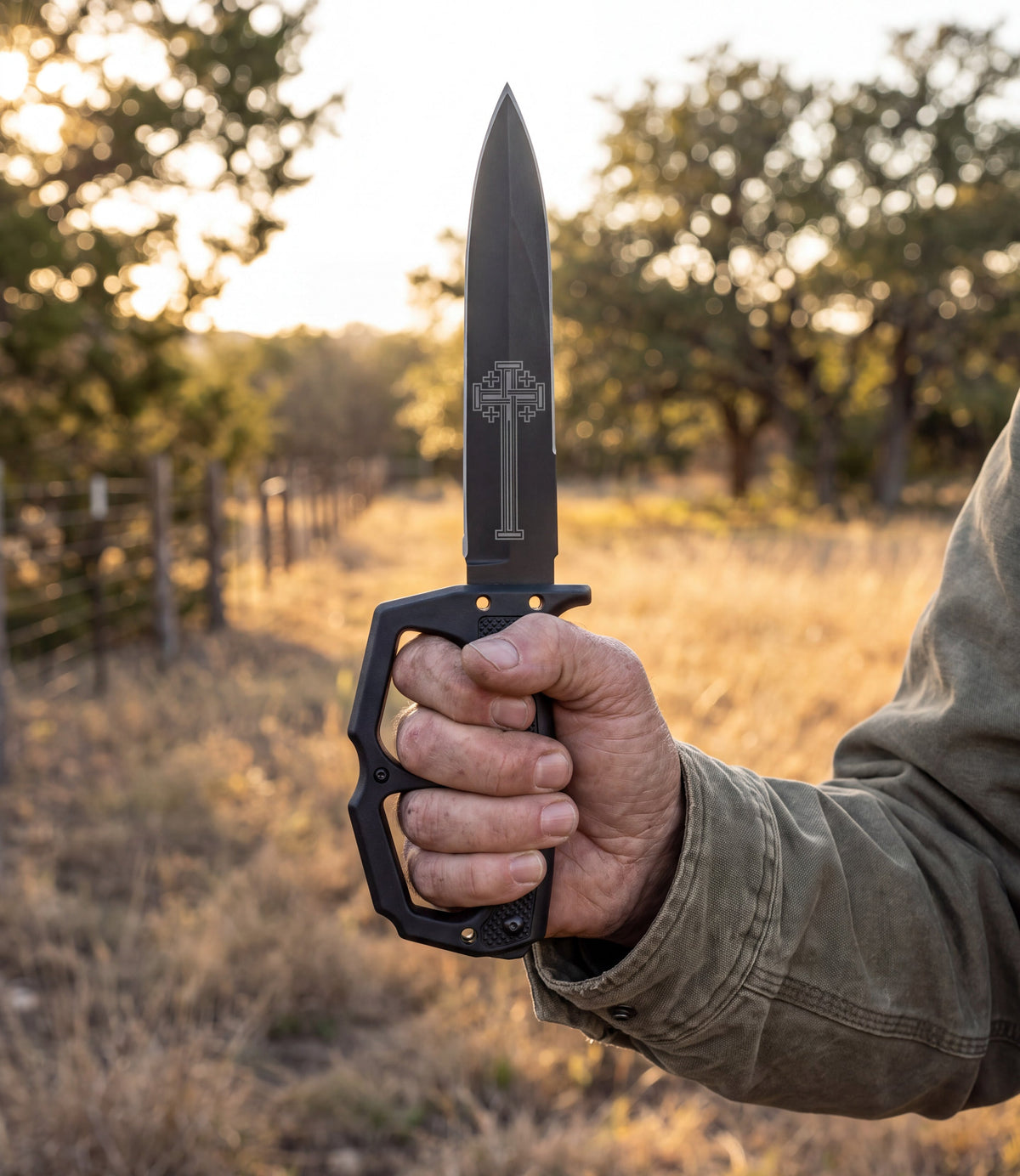 The Alex Jones Store - Ave Christus Rex Trench War Dagger held in hand at a Texas ranch fence line