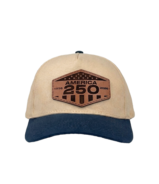 The Alex Jones Store - Cream and navy America 250 patch hat with hexagonal leather '1776-2026 America 250' patch, snapback construction